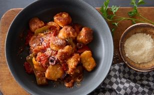 Fried Mortadella sandwich sitting on a small, white plate.