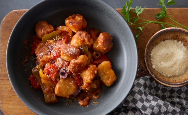 Fried Mortadella sandwich sitting on a small, white plate.
