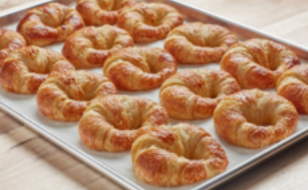 Baked croissants on a tray.